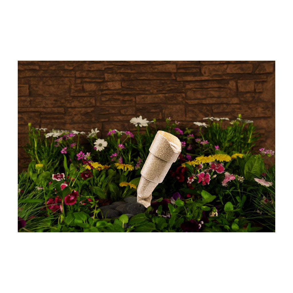 FXL RS series uplight in desert granite in a bed of flowers