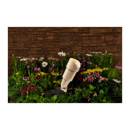 FXL RS series uplight in desert granite in a bed of flowers